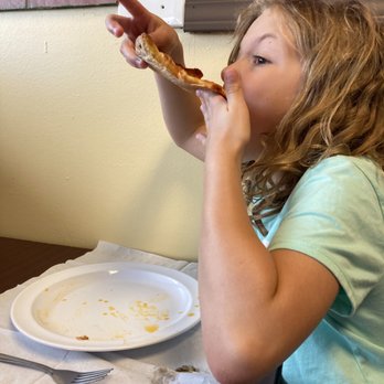 The original Bella's Pizzeria - Kid shoving deliciousness in her face - Pizza Near Me - Yukon, Oklahoma The original Bella's Pizzeria - Kid shoving deliciousness in her face - Pizza Near Me - Yukon, Oklahoma