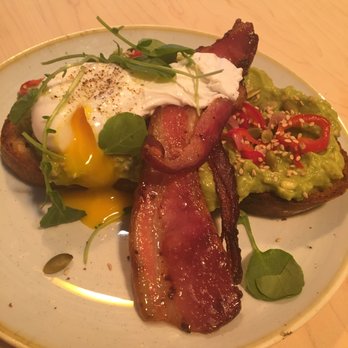 Two Hands - Smashed Avocado on a sourdough with pickled shallots, cilantro, pepitas, sesame, chili and lime with a poached egg and bacon - Breakfast & Brunch Near Me - New York, New York Two Hands - Smashed Avocado on a sourdough with pickled shallots, cilantro, pepitas, sesame, chili and lime with a poached egg and bacon - Breakfast & Brunch Near Me - New York, New York