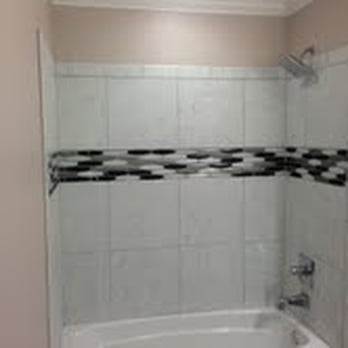 A Plus Tile - a bathtub and shower in a bathroom - General Contractors Near Me A Plus Tile - a bathtub and shower in a bathroom - General Contractors Near Me
