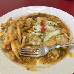 Fernandez Taqueria - Cheese enchiladas with fries instead of beans and rice all smothered with green chili
