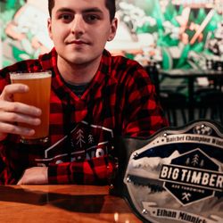 Cheers to victory! Our league champ kicks back with a cold beer in front of a mural by a talented local artist.