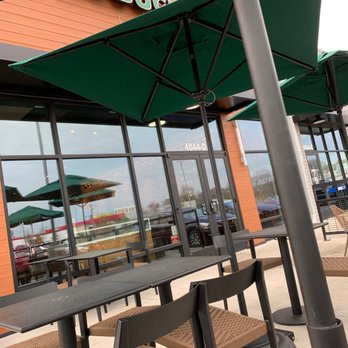 Starbucks - the outside of a coffee shop with tables and umbrellas - Coffee & Tea Near Me - Charlotte, North Carolina