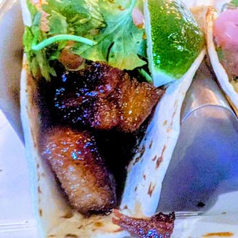Scratch Kitchen and Taproom - PORK BELLY TACOS Pork belly tossed in Thai-chili hoisin glaze with pineapple cucumber salsa, pickled onions, and cilantro. - American Near Me - Cary, North Carolina Scratch Kitchen and Taproom - PORK BELLY TACOS Pork belly tossed in Thai-chili hoisin glaze with pineapple cucumber salsa, pickled onions, and cilantro. - American Near Me - Cary, North Carolina