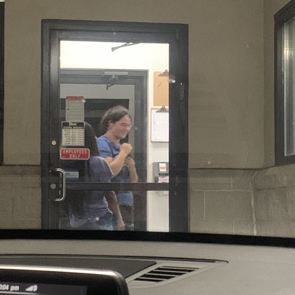 Sonic Drive-In - Employees having a conversation while playing with a CAT, while there's at least 8 cars waiting to pick up food or place order. - Burgers Near Me - Columbus, Ohio