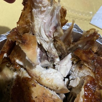 Caridad Restaurant - a person picking up a piece of chicken - Spanish Near Me - Bronx, New York Caridad Restaurant - a person picking up a piece of chicken - Spanish Near Me - Bronx, New York
