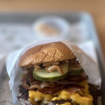 Shake Shack - Smoky Classic BBQ Burger: Qrt. Lb. Angus beef patty topped w/American cheese, bacon, pickles, crispy onions, BBQ sauce & potato bun | $10.99 - Burgers Near Me - Costa Mesa, California