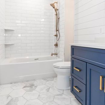Birdland Builders - a bathroom with a blue vanity and a white toilet - General Contractors Near Me - Millersville, Maryland Birdland Builders - a bathroom with a blue vanity and a white toilet - General Contractors Near Me - Millersville, Maryland