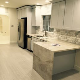 a kitchen with a marble island a kitchen with a marble island