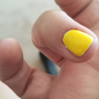 Dip nails - The polish on this nail is thicker in some places more than others and you can still see the white for the white base he put on - Nail Salons Near Me - North Las Vegas, Nevada