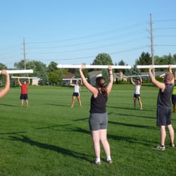 Detroit Slaughter Boot Camp fitness. Barbell jacks exercise.