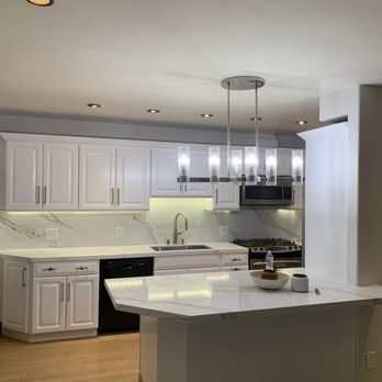 Amparo Construction & Restoration - a kitchen with a center island - General Contractors Near Me