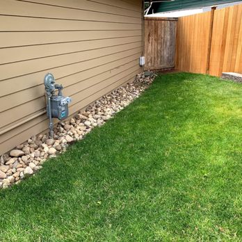 DS Pro Deck and Fence - Showing rock placement next to house. - Landscaping Near Me
