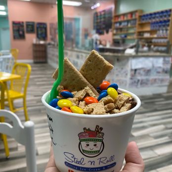 Steel N Roll - a hand holding a cup of cereal - Ice Cream & Frozen Yogurt Near Me - Vero Beach, Florida Steel N Roll - a hand holding a cup of cereal - Ice Cream & Frozen Yogurt Near Me - Vero Beach, Florida