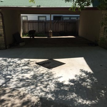 Innovative Water Solutions - New concrete driveway sloped to grated inlet basin - Landscaping Near Me - Austin, Texas