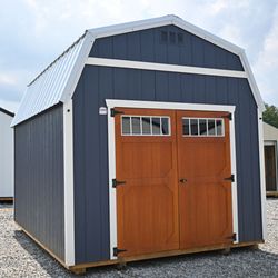 Timberline Barns - Navy blue low wall barn with double front door and white trim.
