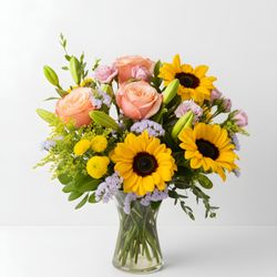Florida Flowers - Sunflowers and peach roses designed in a glass vase.
