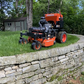 Garpetti Outdoor Solutions - an orange riding mower - Gardeners Near Me Garpetti Outdoor Solutions - an orange riding mower - Gardeners Near Me