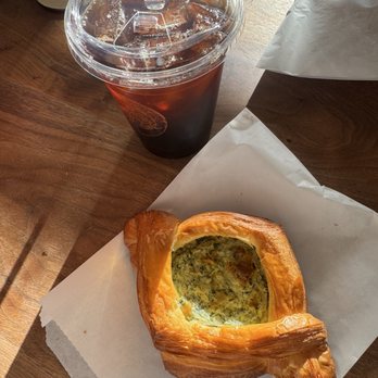 Pangolin Café - Iced coffee and spinach & cheese croissant - Coffee & Tea Near Me - Reno, Nevada Pangolin Café - Iced coffee and spinach & cheese croissant - Coffee & Tea Near Me - Reno, Nevada