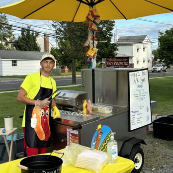 The Homedog - a man standing in front of a hot dog cart - Hot Dogs Near Me