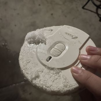 Team Thompson Plumbing - a hand holding a smoke detector - Plumbing Near Me - Prineville, Oregon