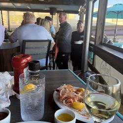 Red, White & Booze - A boss waitress navigating the impossible bottle neck. Outdoor bar action. Locals all know each other