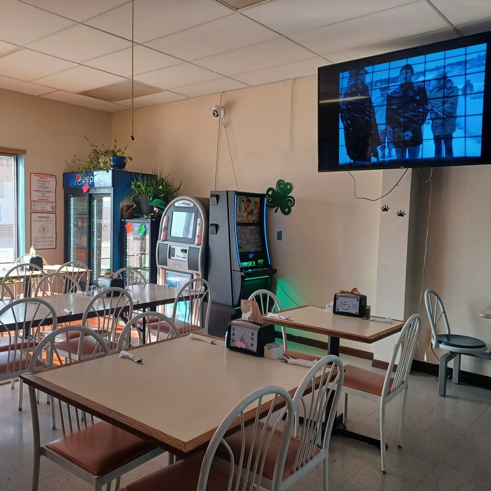 Bear-n-T’s Hideaway - ows a man watching television in a restaurant - Burgers Near Me - Alexandria, Nebraska