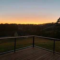 OS Fabrication and Design - Sunset on the open end of the deck with cable railing system.