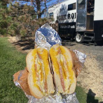 North Eats - a person holding a sandwich in front of a train - Food Stands Near Me - Asbury Park, New Jersey North Eats - a person holding a sandwich in front of a train - Food Stands Near Me - Asbury Park, New Jersey