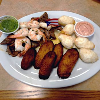 A Fuego 787 - Criolla style steak & shrimps, sweet plantains, chimichurri & mayo-ketchup condiments, cheese filled yuca fritters known as cheese balls. - Empanadas Near Me - Columbia, South Carolina