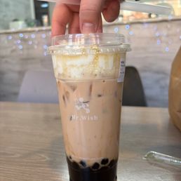 black tea boba with macchiato foam on top. black tea boba with macchiato foam on top.