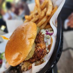 Alamar Marina Resturant & Bar - Fried chicken breast tossed in spicy Nashville sauce drizzled w/ honey, mayo, coleslaw, pickles on a brioche bun, served w/ choice of side.