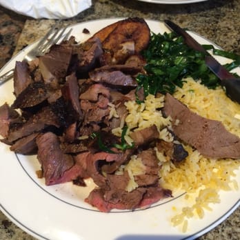Oliveira's Steak House - Sirloin, lamb, pork shoulder some rice and collard greens. - Brazilian Near Me - Boston, Massachusetts Oliveira's Steak House - Sirloin, lamb, pork shoulder some rice and collard greens. - Brazilian Near Me - Boston, Massachusetts