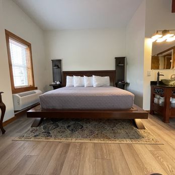 Damascus Old Mill - a bedroom with a bed, dresser and mirror - Bed & Breakfast Near Me - Damascus, Virginia