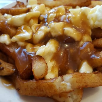 Vincent Sous-Marins - a plate of french fries covered in gravy - Poutineries Near Me - Montreal, Quebec Vincent Sous-Marins - a plate of french fries covered in gravy - Poutineries Near Me - Montreal, Quebec