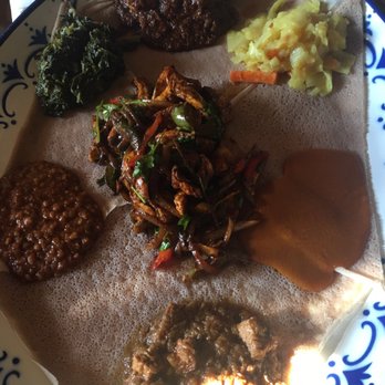 Ghenet Brooklyn - Platter for one w the doro tibs dish in the center - Ethiopian Near Me - Brooklyn, New York