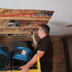 The Dry Out Guys - One of our technician's checking the moisture in the wood to make sure it is drying properly