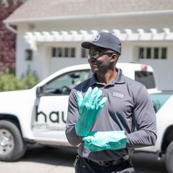Hawx Pest Control - Hawx technician gearing up for residential service--gloves, eyewear, and truck ready to treat ants, spiders, and other pests.