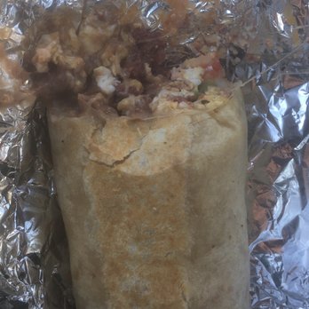 Dos Hermanos - Half (almost the size of my hand) of my breakfast burrito with chorizo, egg, potato, rice, refried beans, cheese, and tomato. - Mexican Near Me - Fort Worth, Texas