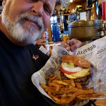 Captain Mike's - My hubby with his grumpy face  on because I wanted to take his picture with the burger - Burgers Near Me - Kenosha, Wisconsin