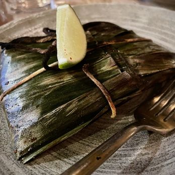 Sama Sama Kitchen - Pepes Ikan - local black cod grilled in banana leaves, coconut sambal, cherry tomatoes, and fresh herbs - Cocktail Bars Near Me - Santa Barbara, California