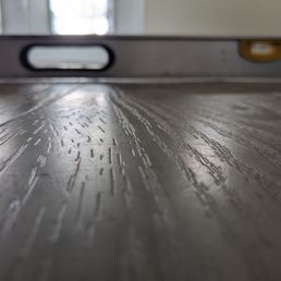 Floor uneven where no leveling cement was used causing separating and chipping. Floor uneven where no leveling cement was used causing separating and chipping.