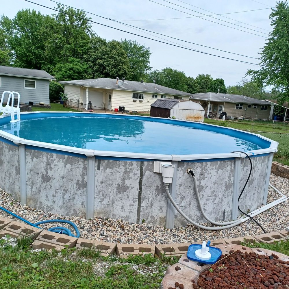 Pebble Brook Pool & Spa - The pump is hidden on the other side of the pool where the hoses and PVC are going on the right - Pool & Hot Tub Service Near Me Pebble Brook Pool & Spa - The pump is hidden on the other side of the pool where the hoses and PVC are going on the right - Pool & Hot Tub Service Near Me