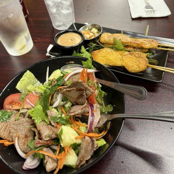 Tasty Thai - Beef salad with satay chicken appetizer. - Thai Near Me - Arroyo Grande, California Tasty Thai - Beef salad with satay chicken appetizer. - Thai Near Me - Arroyo Grande, California