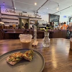 Coracle Coffee - View from a booth with iced coffee and avocado toast at Coracle Coffee in downtown Tulsa.