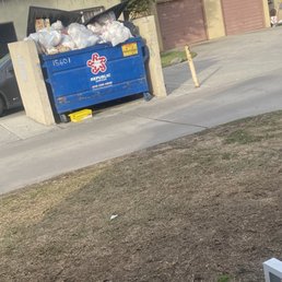 Over flowing trash bin located right outside if residents door Over flowing trash bin located right outside if residents door