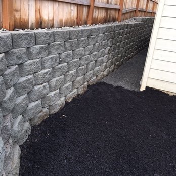 Water Rite - a large pile of black mulch next to a fence - Irrigation Near Me - Vancouver, Washington Water Rite - a large pile of black mulch next to a fence - Irrigation Near Me - Vancouver, Washington