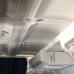 Pillowcase stuffed into the ceiling of the plane.