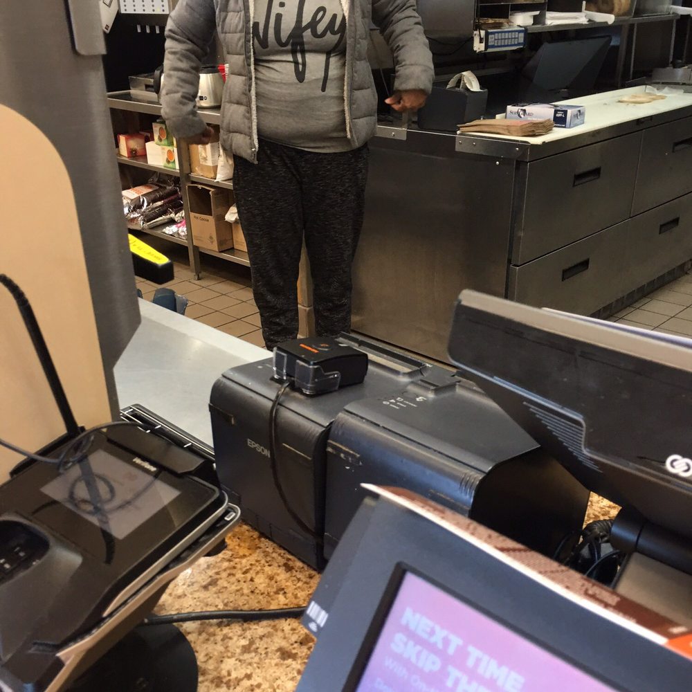 a woman standing at a cash register a woman standing at a cash register