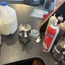 BIGGBY COFFEE - A severe lack of condensation on the milk container after being left out for over 30 minutes indicates inadequate temperature storage.
