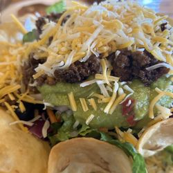 Cowboys and Angel's place - Come now, isn't that a masterpiece taco salad? Extra shredded cheese below, and it is not half lettuce!!